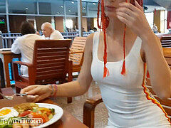 woman with red hair sits pantyless in a public dining room