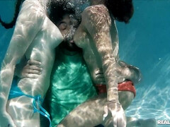 Three lovers relax in the pool by playing orgy games