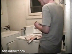 Boy-next-door spreads his new straight porn magazine on top of the washing machine and pulls his cock out of the fly.