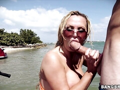 Nikki Benz sitting on her watercraft sucking his shaft