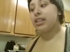 busty latina squeezing milk out of her tit at home