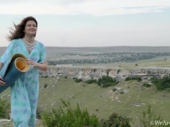 Elena V masturbates outdoors on her yoga mat