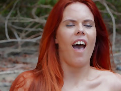 Red-headed Gala Brown moaning with pleasure during passionate sex on the beach