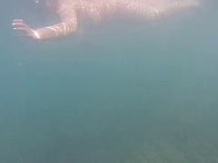 Swimming on the nude beach of Santorini, Greece